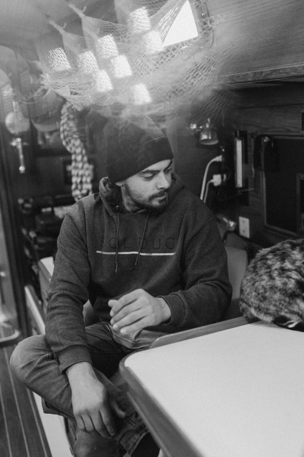man inside his boat on captains chair, black and white, sailing with phoenix